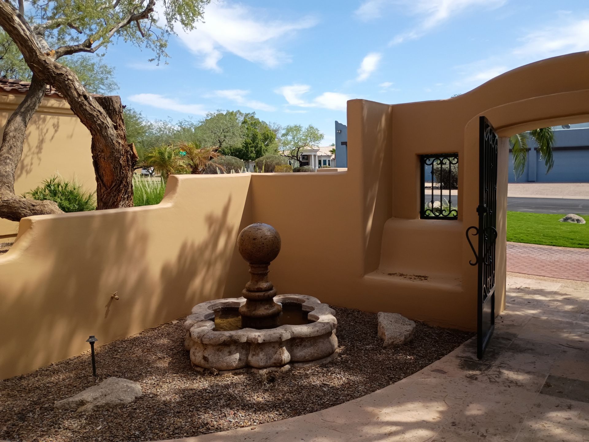 Finished entry courtyard wall and fountain on a East Valley home