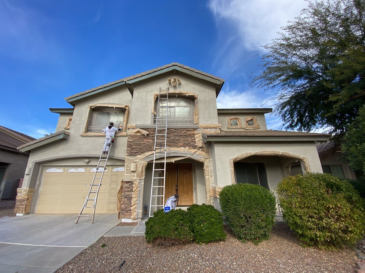 Crash of Rhinos employee masking and painting a Surprise home