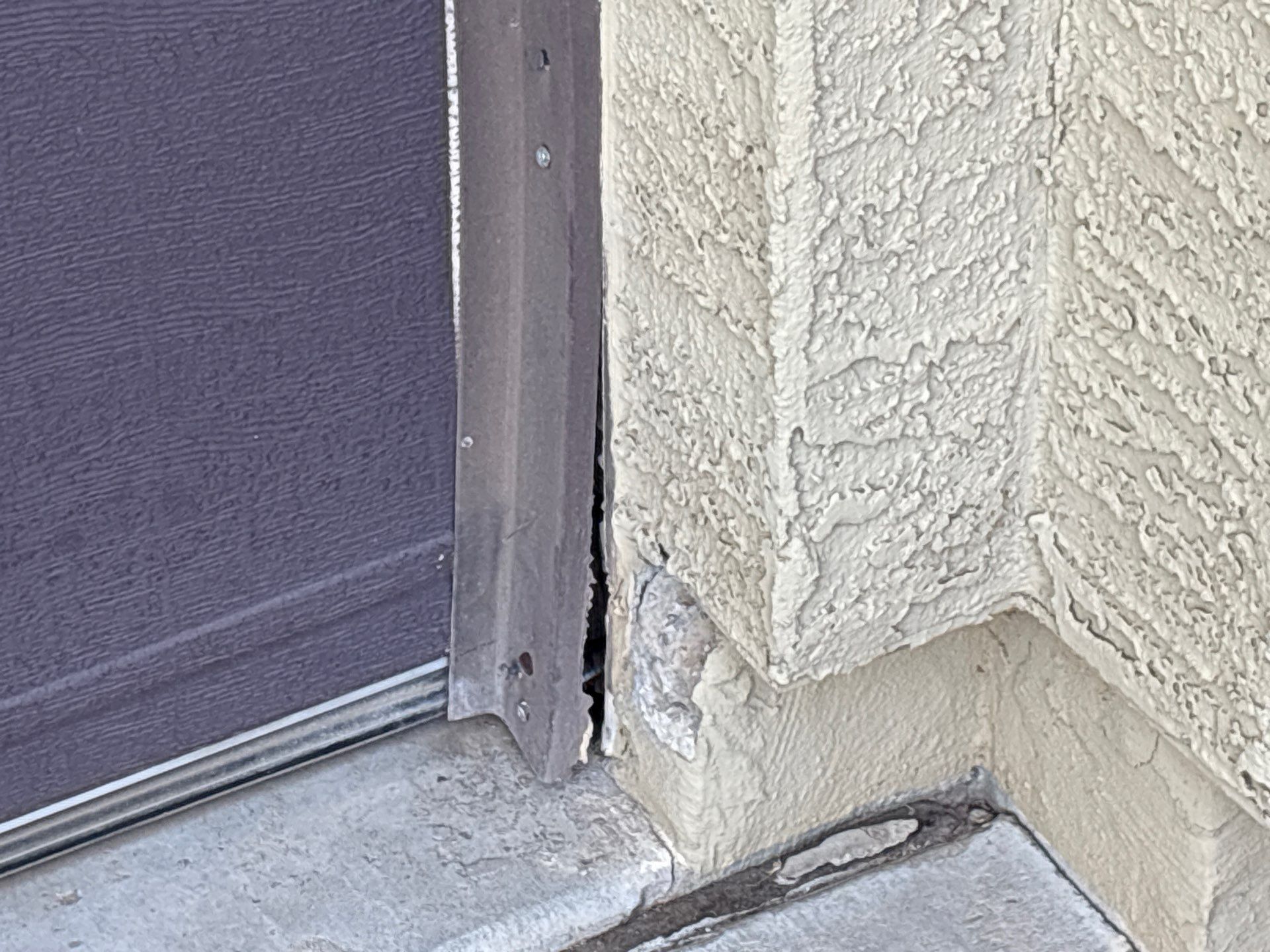 Cracked stucco at a Chandler door jamb before repair