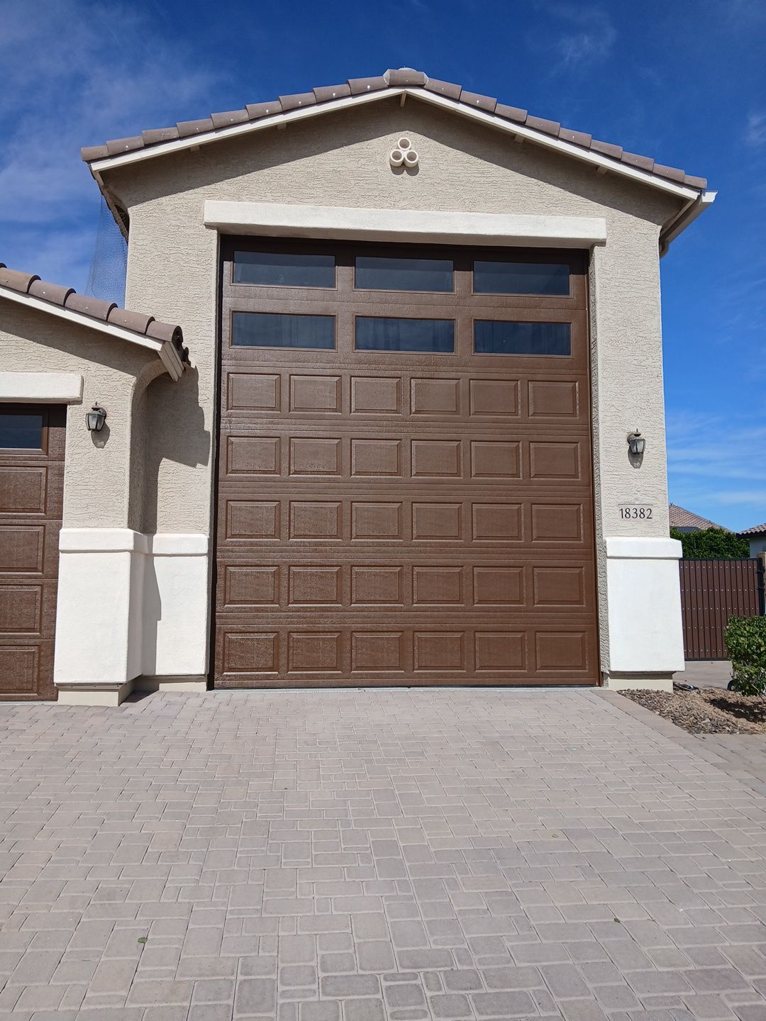 Finished garage door and stucco elevation on a Goodyear home