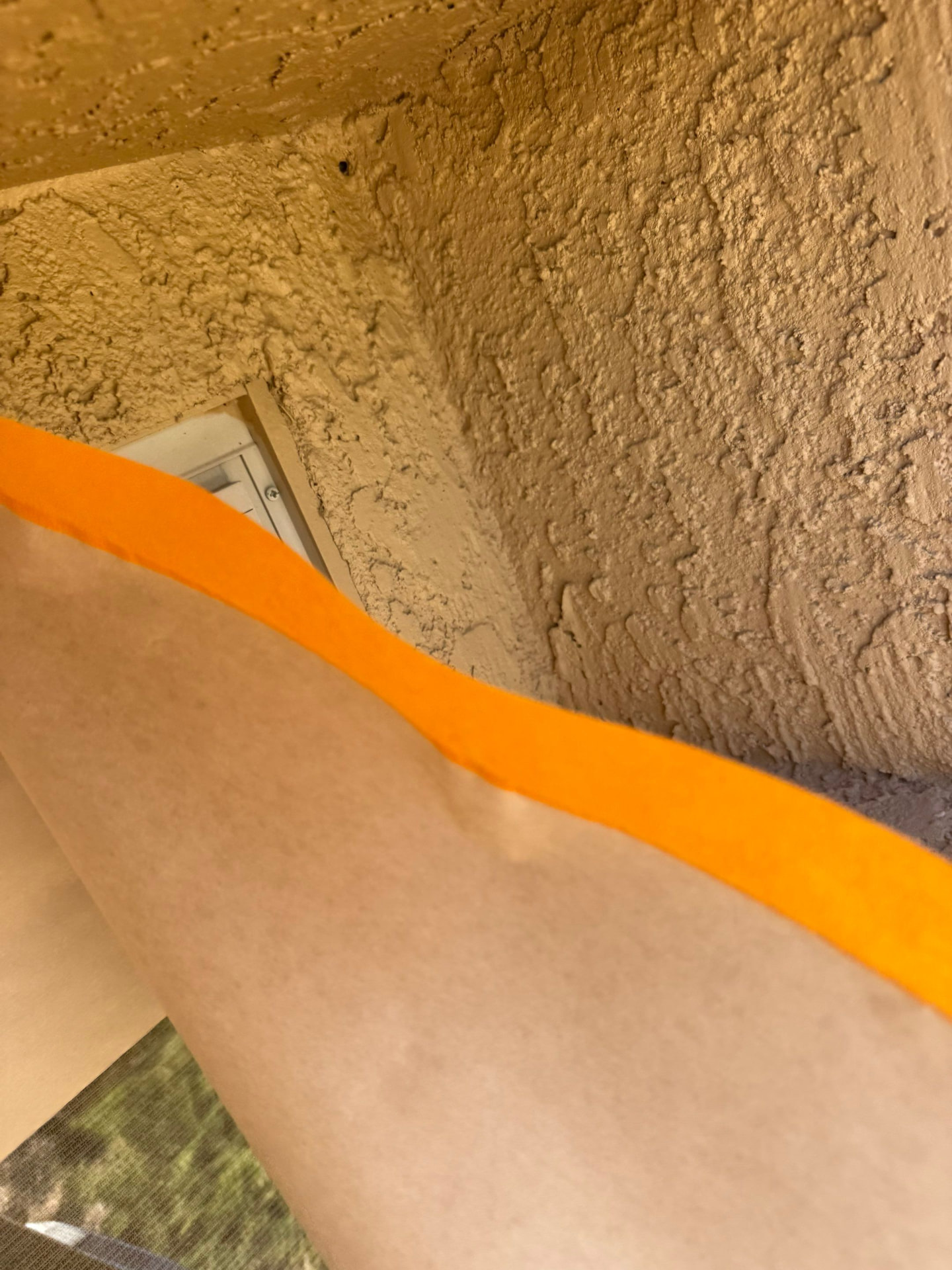 Masked eave and light fixture on a Surprise home during painting