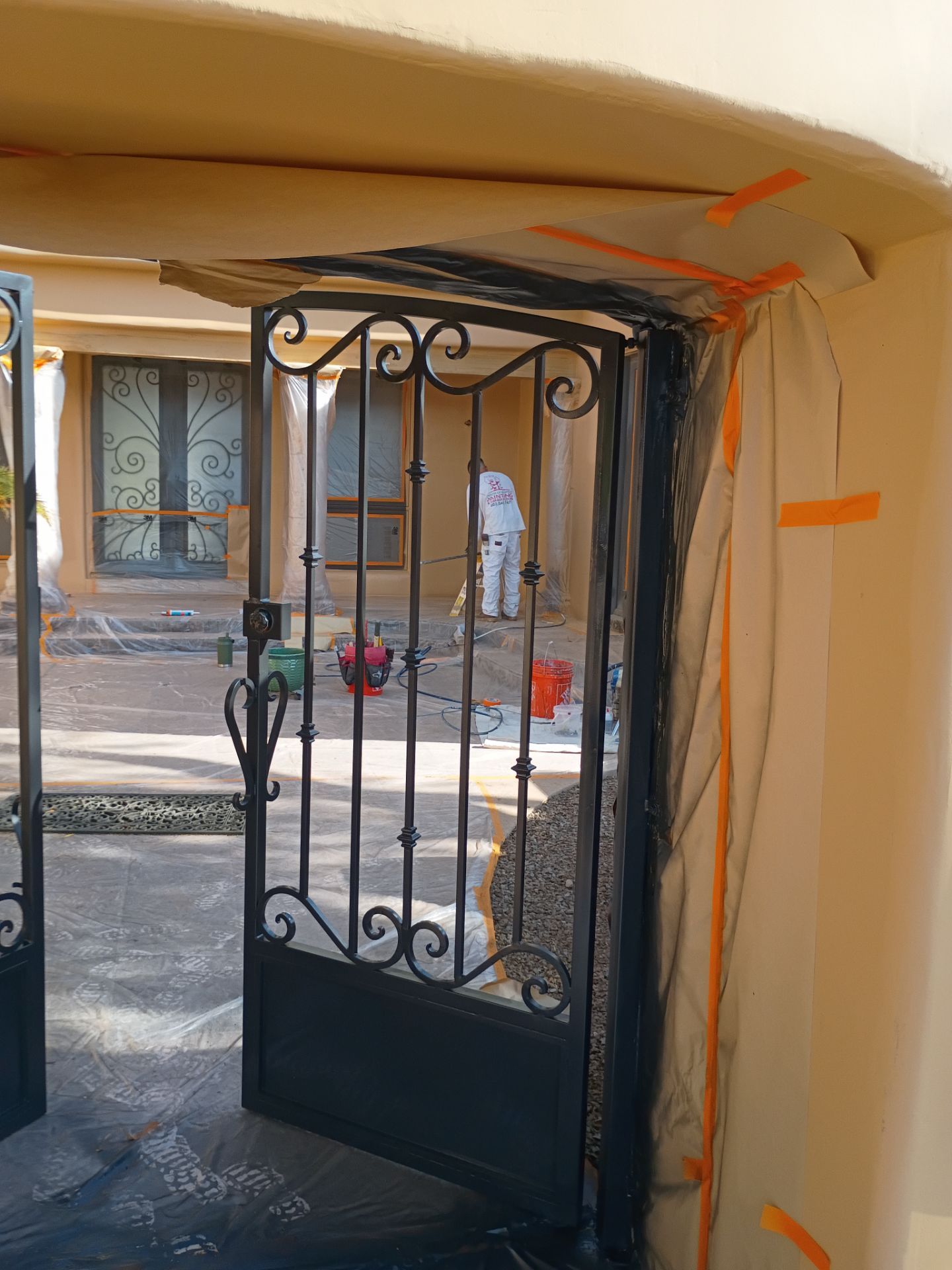 Masked entry gate and courtyard during a East Valley exterior repaint
