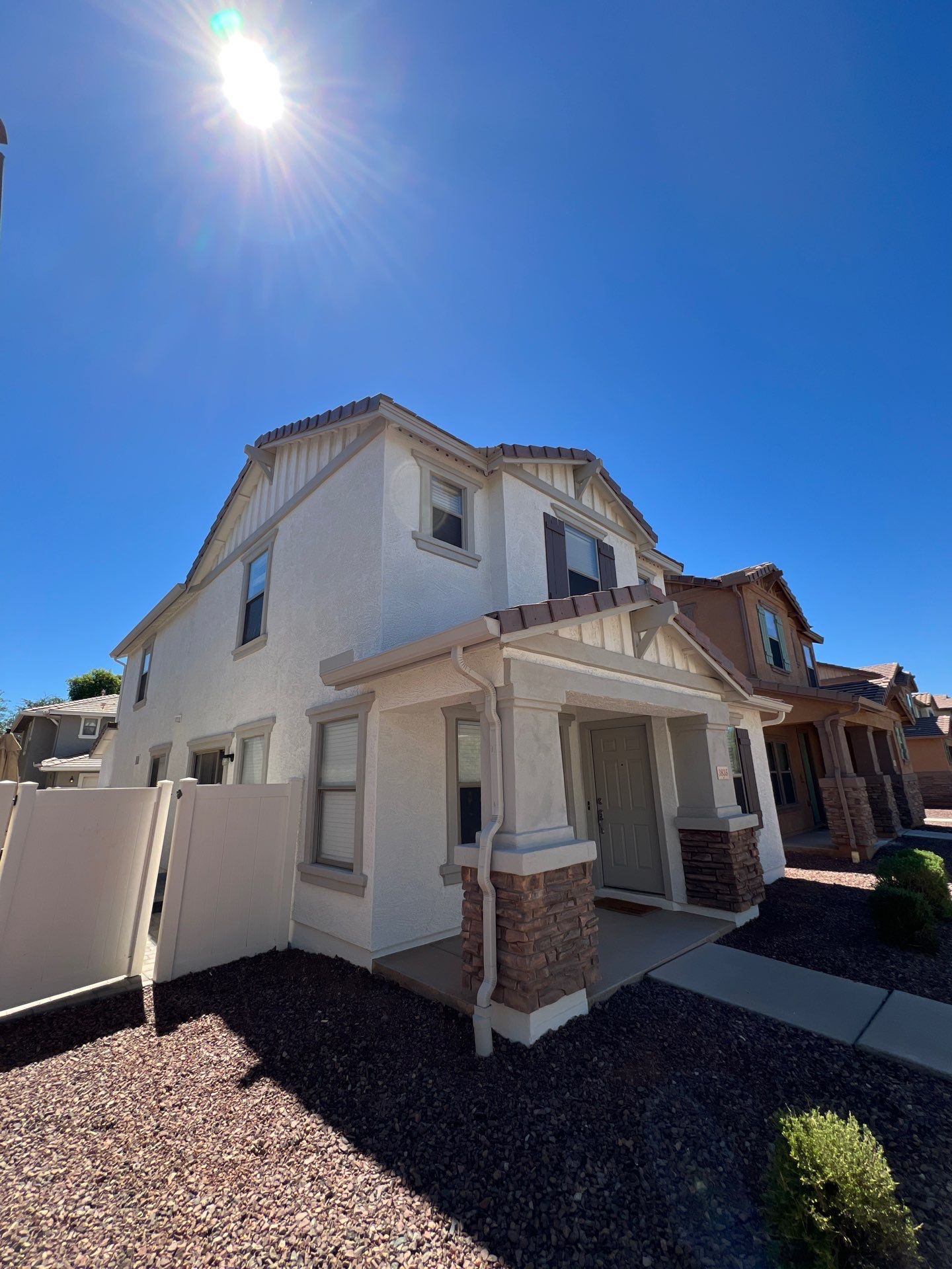 Two-story Gilbert home repainted in a clean warm white
