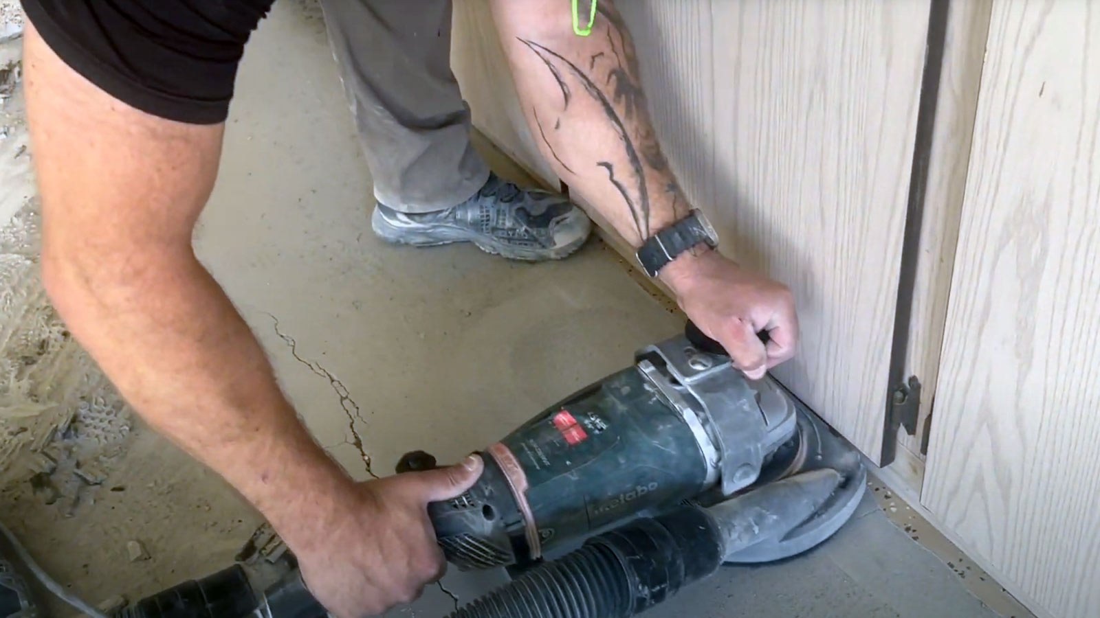 Diamond grinding the edges of a concrete garage floor with dust extraction