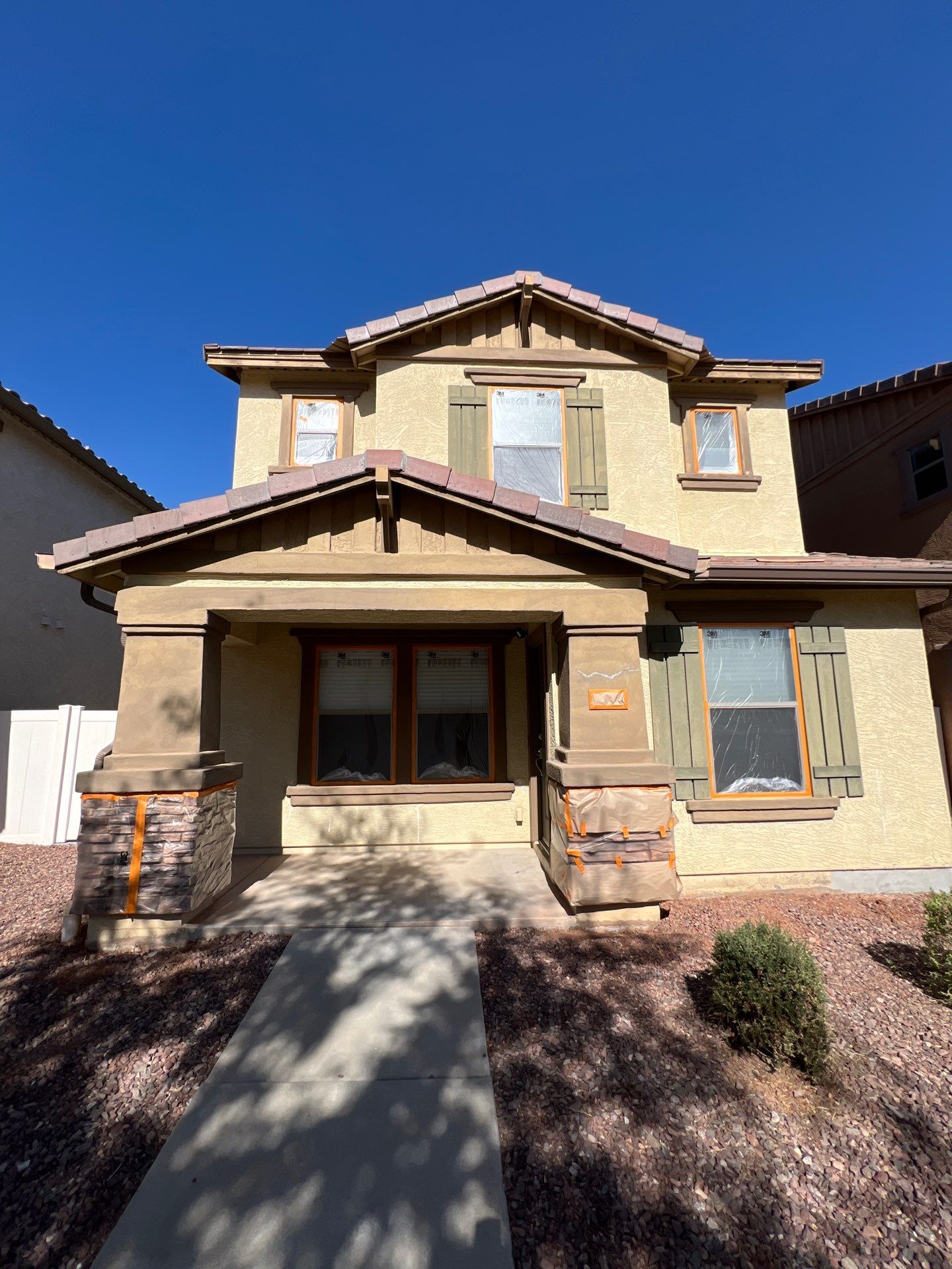 Front elevation of a Gilbert home fully masked before spraying