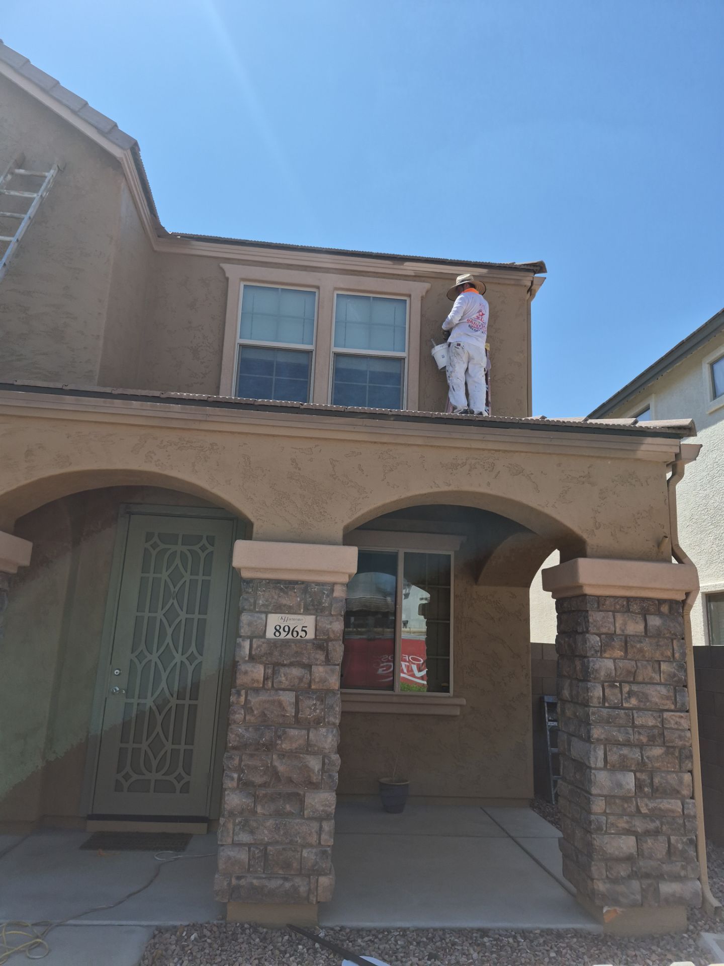 Crash of Rhinos employee painting the upper exterior of a Glendale home