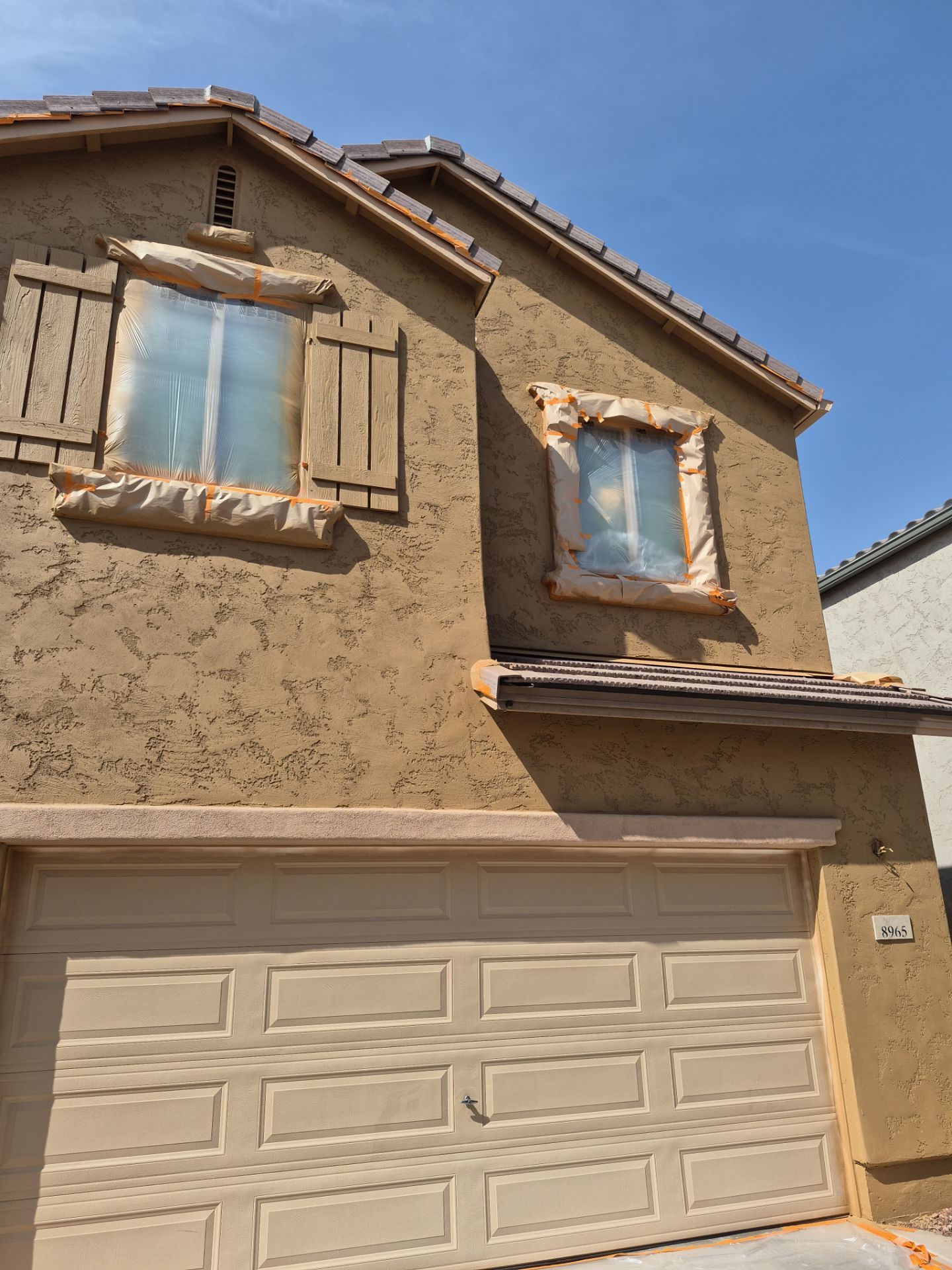 Glendale home with windows masked for exterior painting