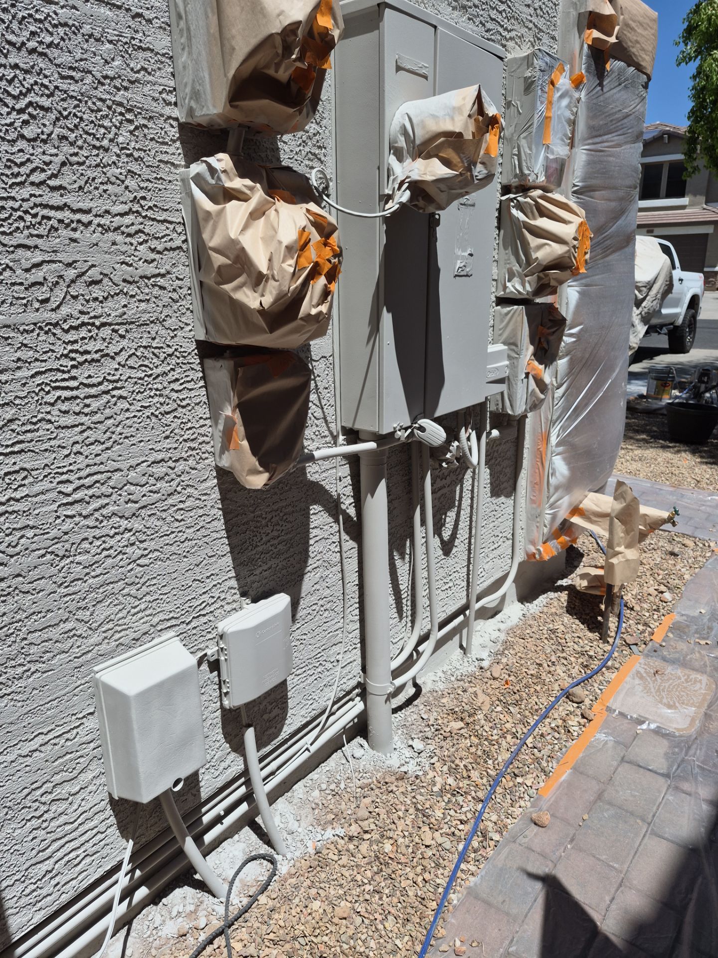 Masked electrical panel and fixtures on a Sun City home during painting