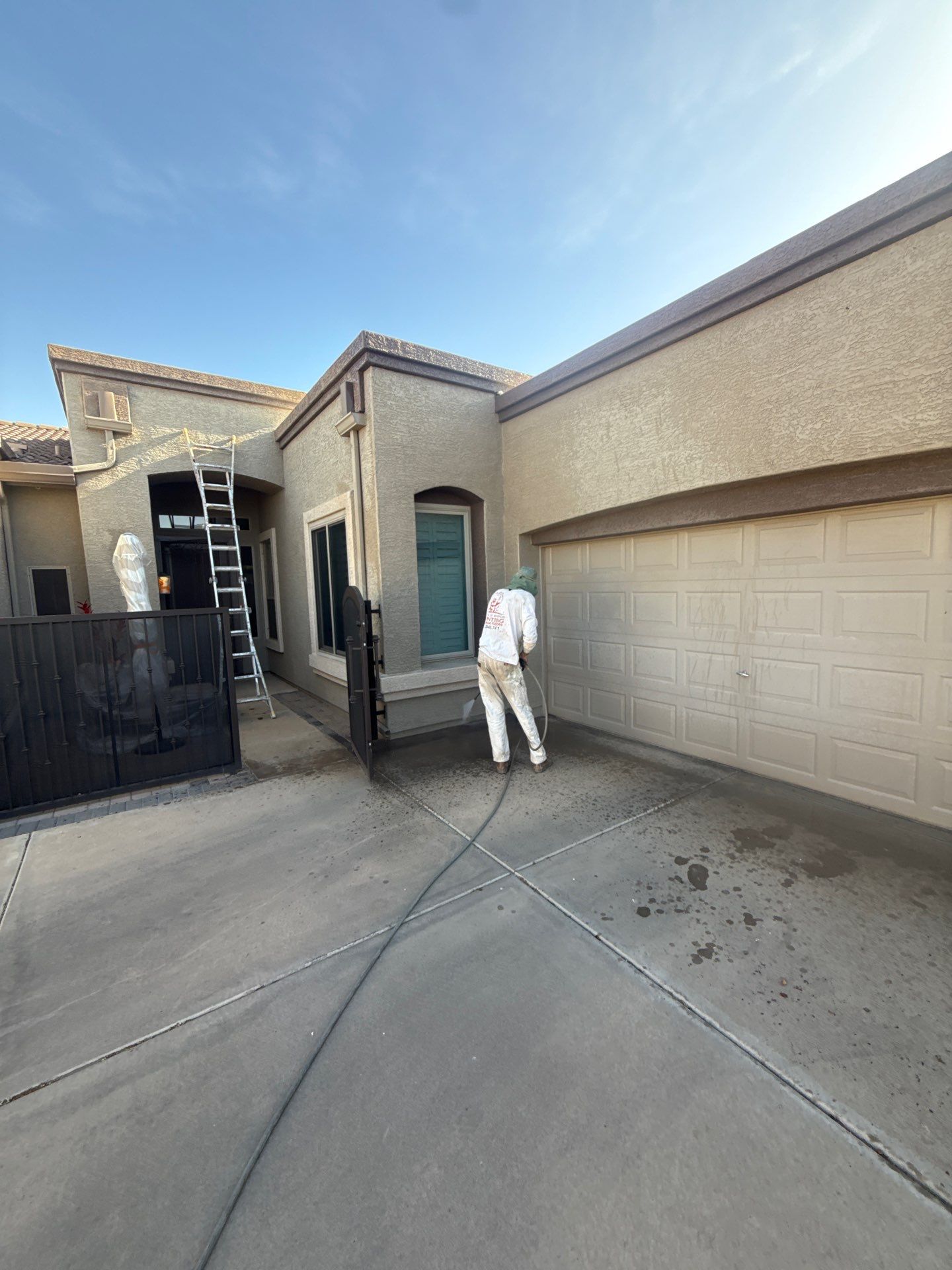 Crash of Rhinos painter pressure washing a Gilbert home exterior