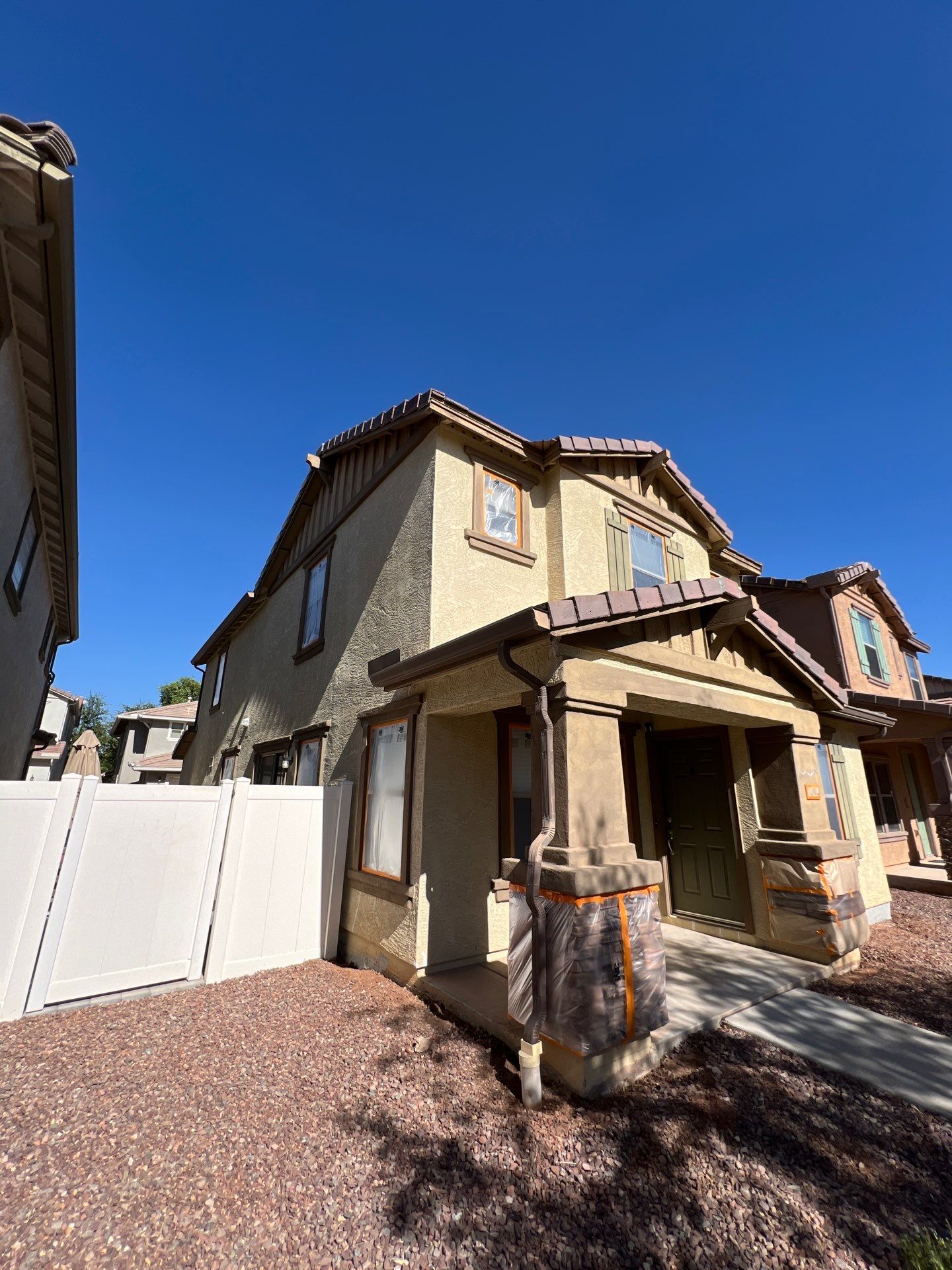 Side elevation of a Gilbert two-story home prepped for painting