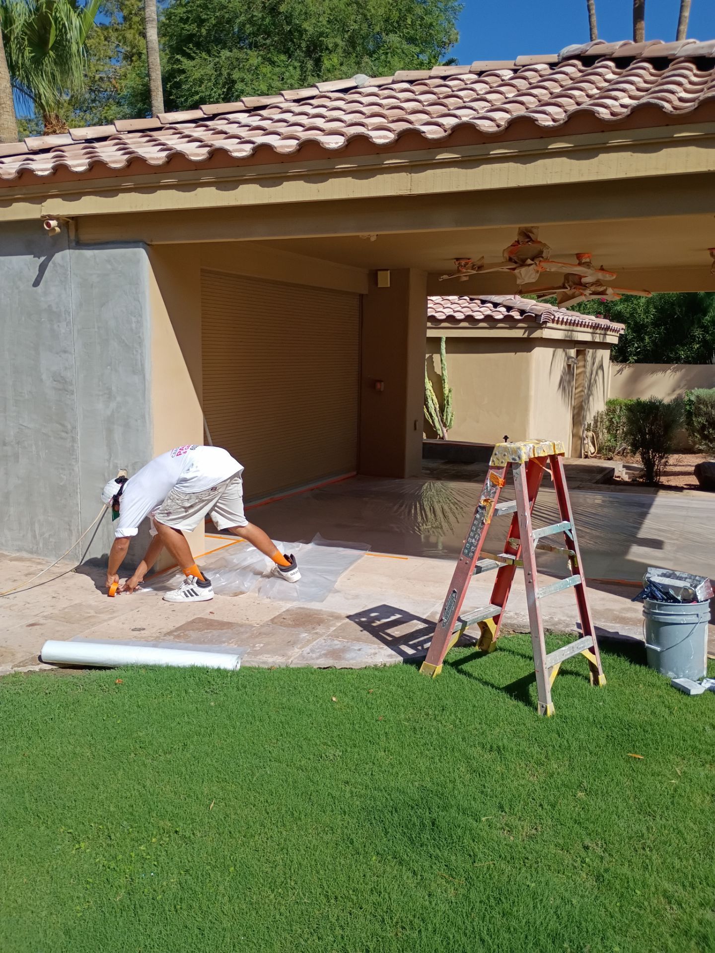 Crash of Rhinos crew prepping a patio and garage wall in East Valley