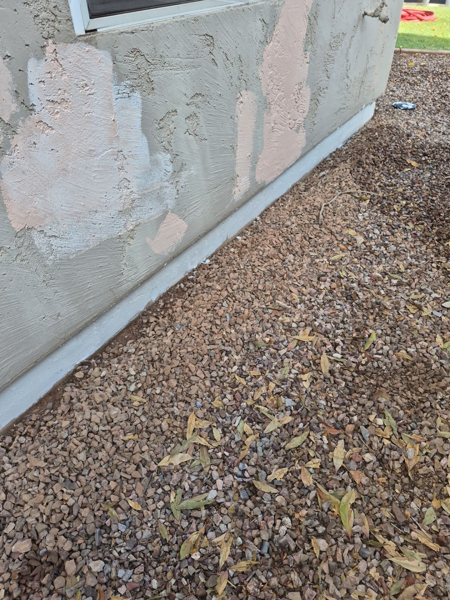 Patched stucco on a Peoria exterior wall before the color coat