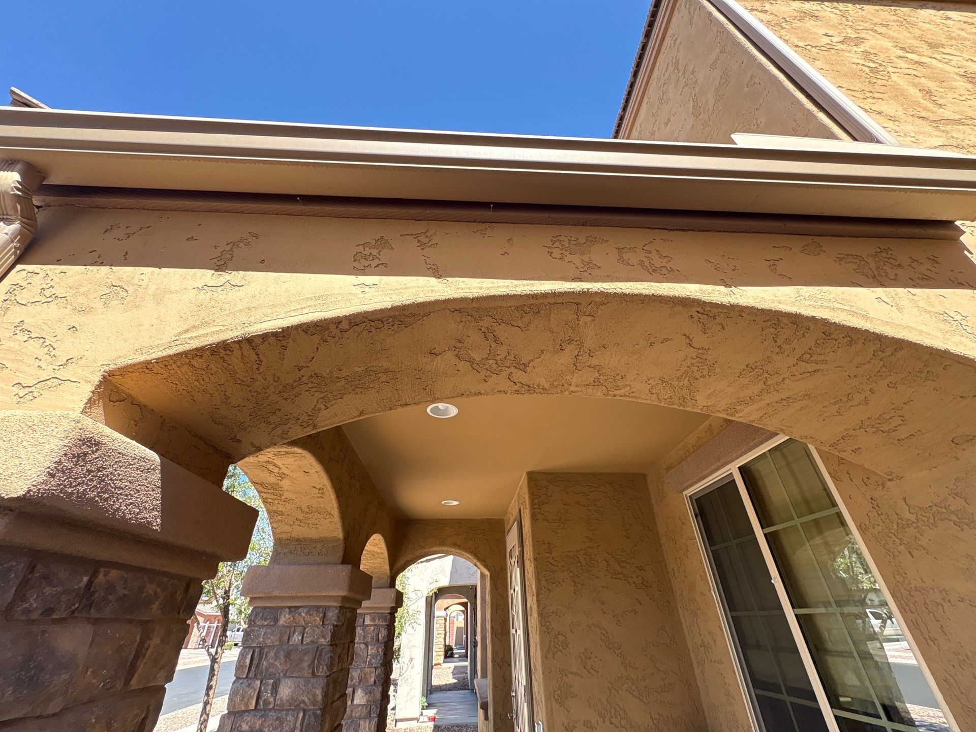 Covered walkway and stone columns on a Glendale home before repainting