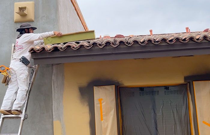 painter protecting clay roof tiles at phoenix house