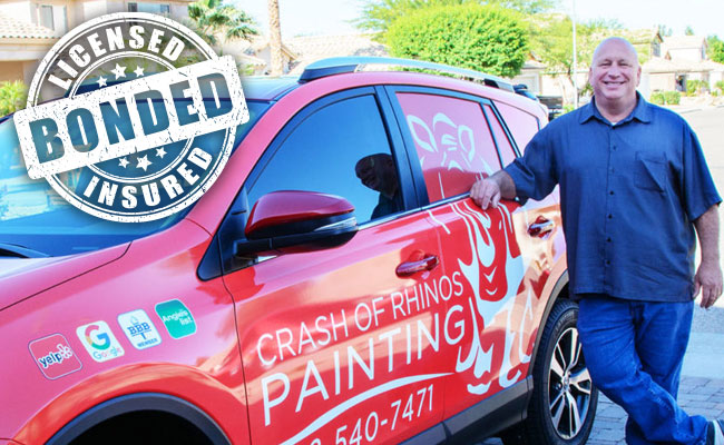 Mike of Crash of Rhinos Painting beside a company vehicle