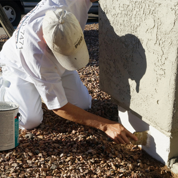 Our painter applies primer to the stem wall of this home, creating an ideal surface for the paint to adhere to.