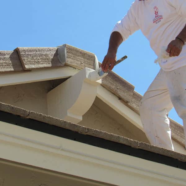 Our painters in Gilbert, AZ never lose sight of the small details, as our painter climbs the roof to brush a decorative fixture.